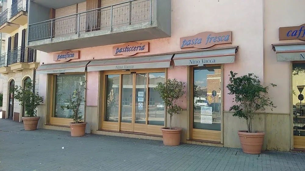 The image is a well-lit, photo-realistic capture of a storefront. The main elements, including the shop signs and entrance, are in clear focus, and the colors appear natural. The composition is straightforward and effective, centering the subject adequately. While generally sharp, the image could benefit from slightly higher detail resolution for optimal clarity.
