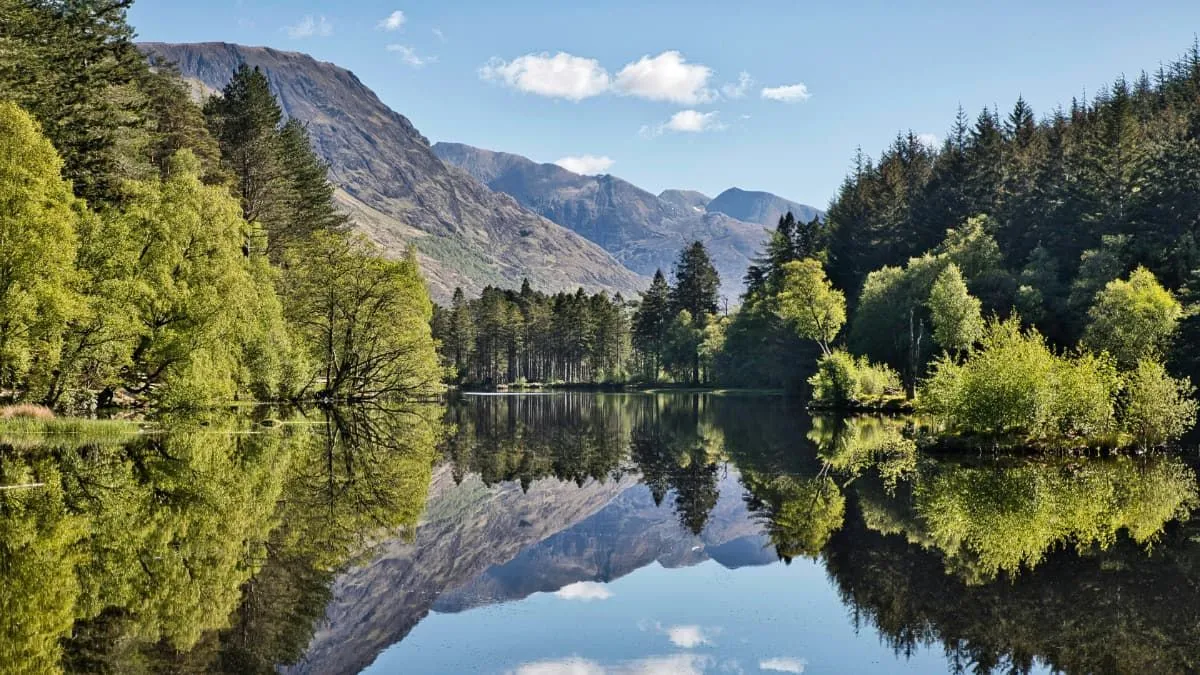 The image is a stunning, high-quality landscape photograph. It is exceptionally well-composed with a striking reflection, perfectly lit with natural light, and sharp throughout. The colors are accurate and vibrant, contributing to its strong photo-realism. All essential elements are in sharp focus.