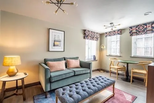 The image displays a well-composed and sharp interior scene, featuring a sofa, an ottoman, and windows, all clearly in focus. The lighting is good, contributing to accurate and pleasing colors, and the overall image is highly photo-realistic. The composition effectively showcases the room's layout and decor.