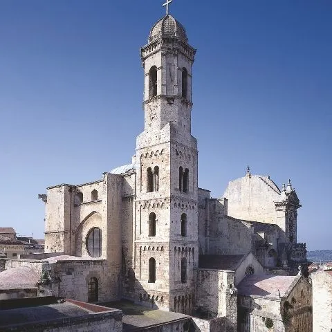 The image is a high-quality photograph of a historical building, likely a church or cathedral. It is exceptionally well-composed, with the main subject prominently featured and effectively filling the frame. The lighting is excellent, providing clear visibility of the architectural details and creating good contrast. The image is sharp throughout, ensuring that all key elements, especially the intricate stonework of the building, are in perfect focus. Colors appear accurate and natural, contributing to the overall photo-realistic quality of the image. No unwanted elements are present.
