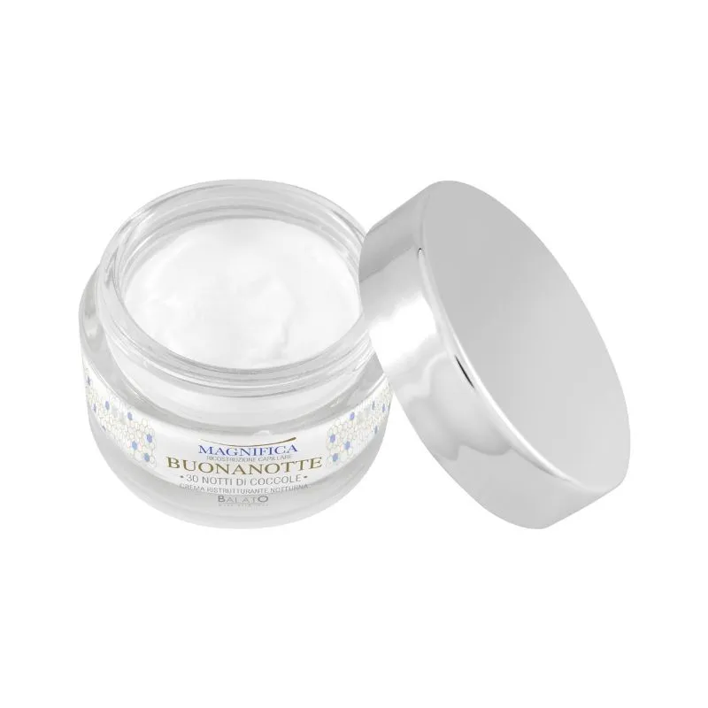 A high-quality product photograph of an open jar of white night cream, with its silver lid slightly ajar, set against a pure white background.