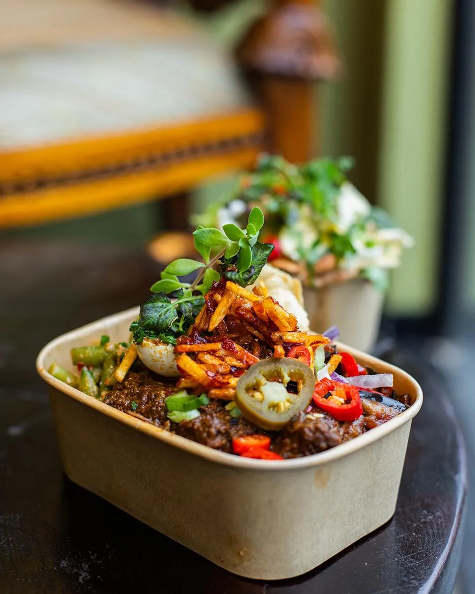 The image features a well-composed and professionally lit close-up of a food dish. The primary subject is sharp and in focus, showcasing vibrant and color-accurate ingredients. The overall photo-realism is high, making the food look appealing and authentic.