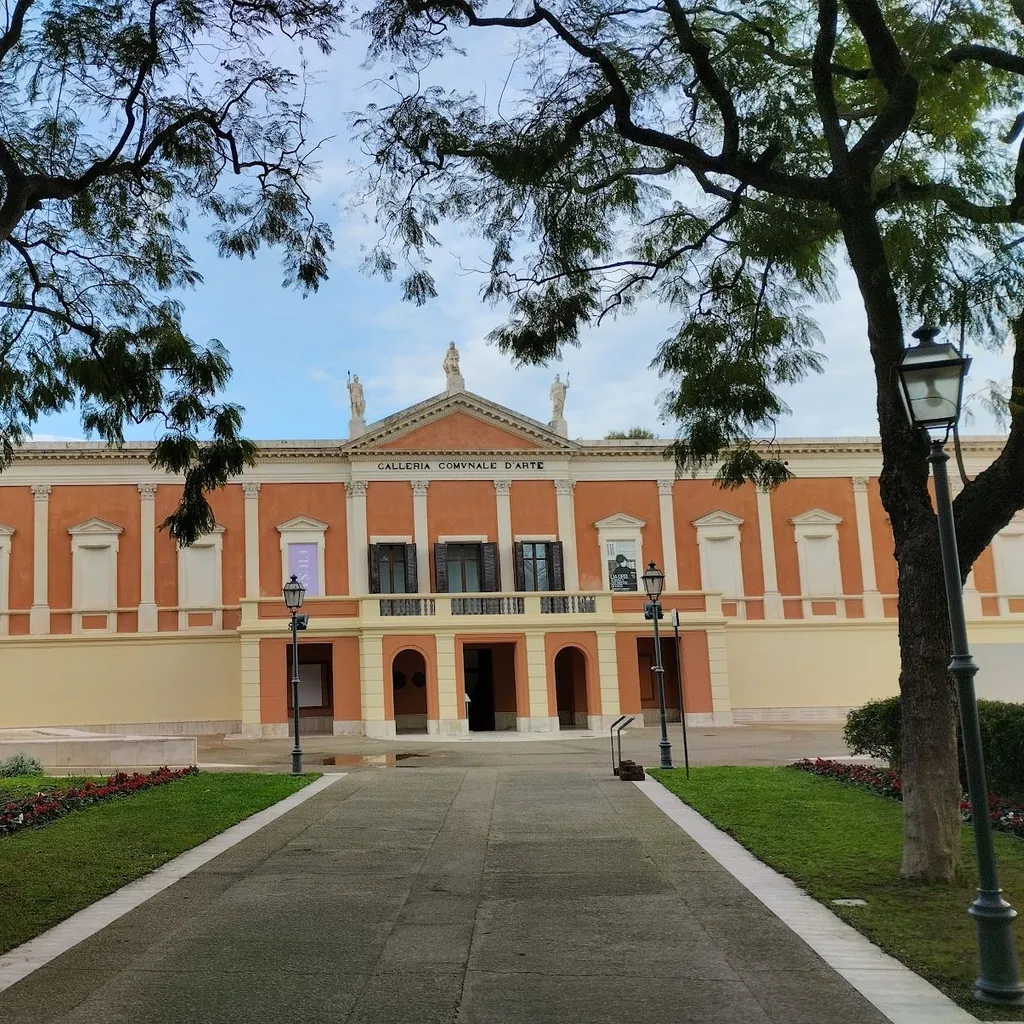 The image features a well-composed shot of a building, framed by trees and approached by a path, giving it an editorial style. The main subject, the building, is sharp and the overall image is highly photo-realistic with accurate colors. However, the lighting is somewhat flat due to overcast conditions, which reduces the overall visual impact and dynamism of the scene.