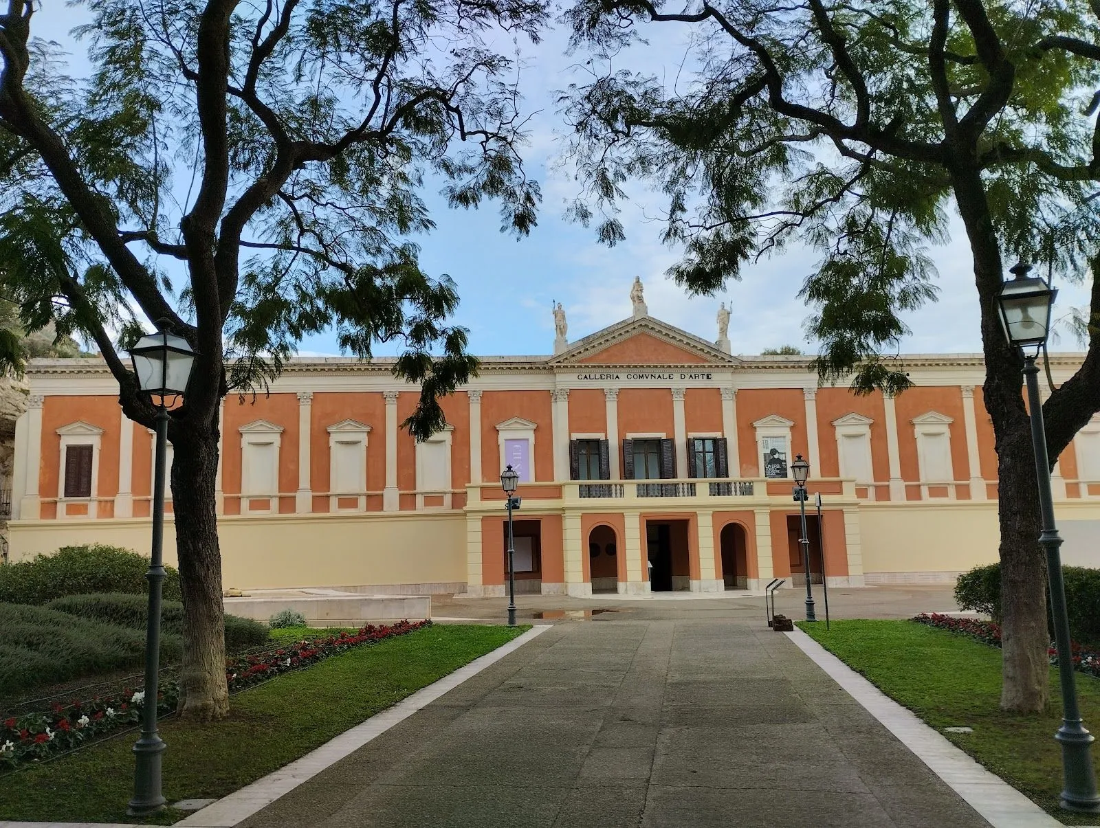 The image features a well-composed shot of a building, framed by trees and approached by a path, giving it an editorial style. The main subject, the building, is sharp and the overall image is highly photo-realistic with accurate colors. However, the lighting is somewhat flat due to overcast conditions, which reduces the overall visual impact and dynamism of the scene.