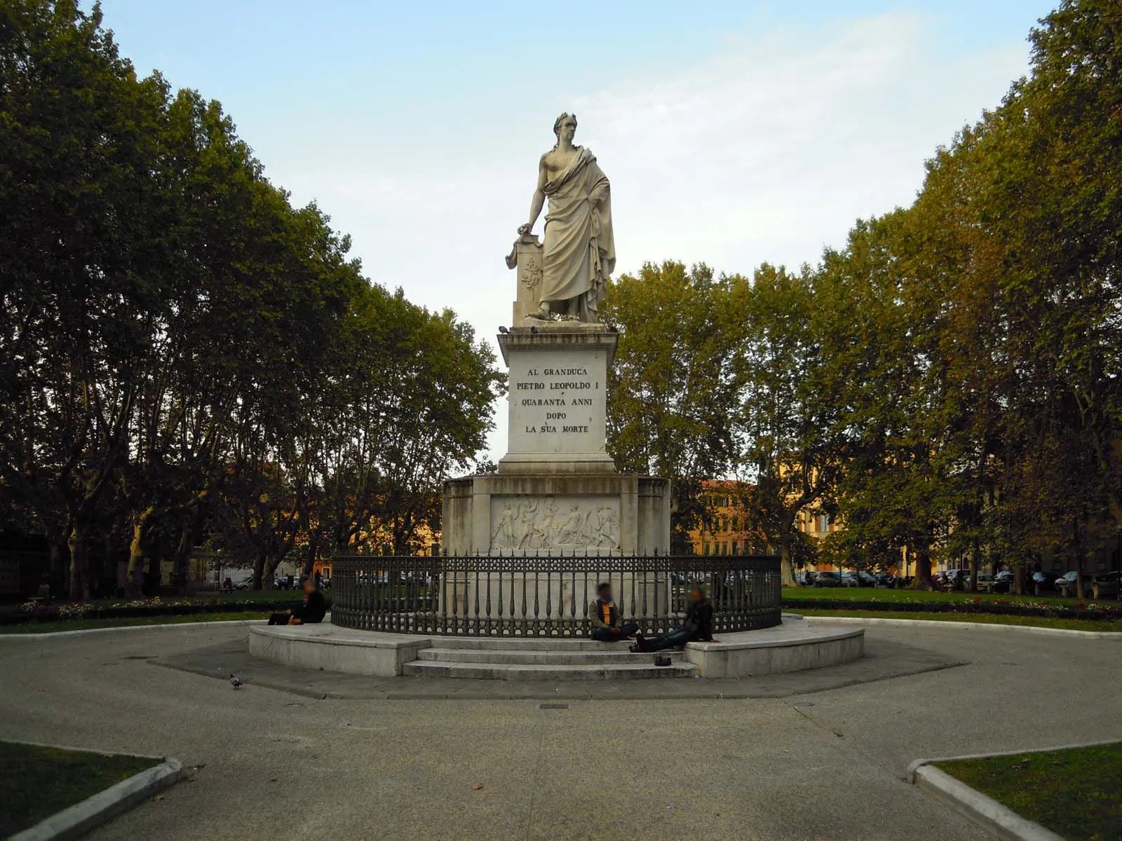 The image is well-composed with the statue centrally placed and framed by the surrounding trees, ensuring the main subject is prominent. It is sharp and clearly photo-realistic, with all key elements, especially the statue, in good focus. Colors appear accurate and natural. The primary area for improvement is the lighting, which is somewhat flat and lacks strong contrast, leading to a less dynamic appearance than ideal.