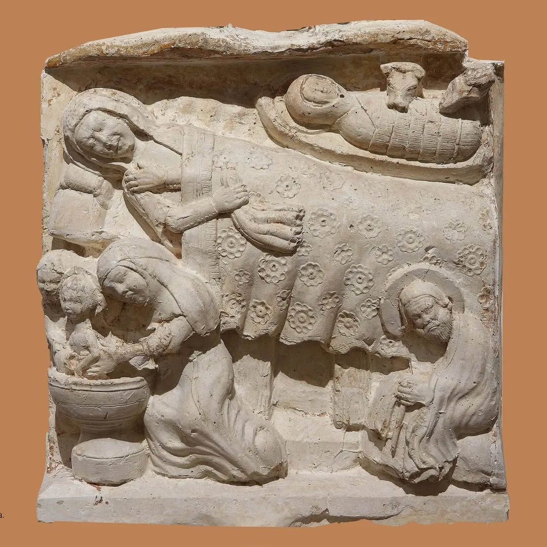 A high-quality photograph of an ancient bas-relief sculpture depicting multiple figures, showcasing intricate details and texture.