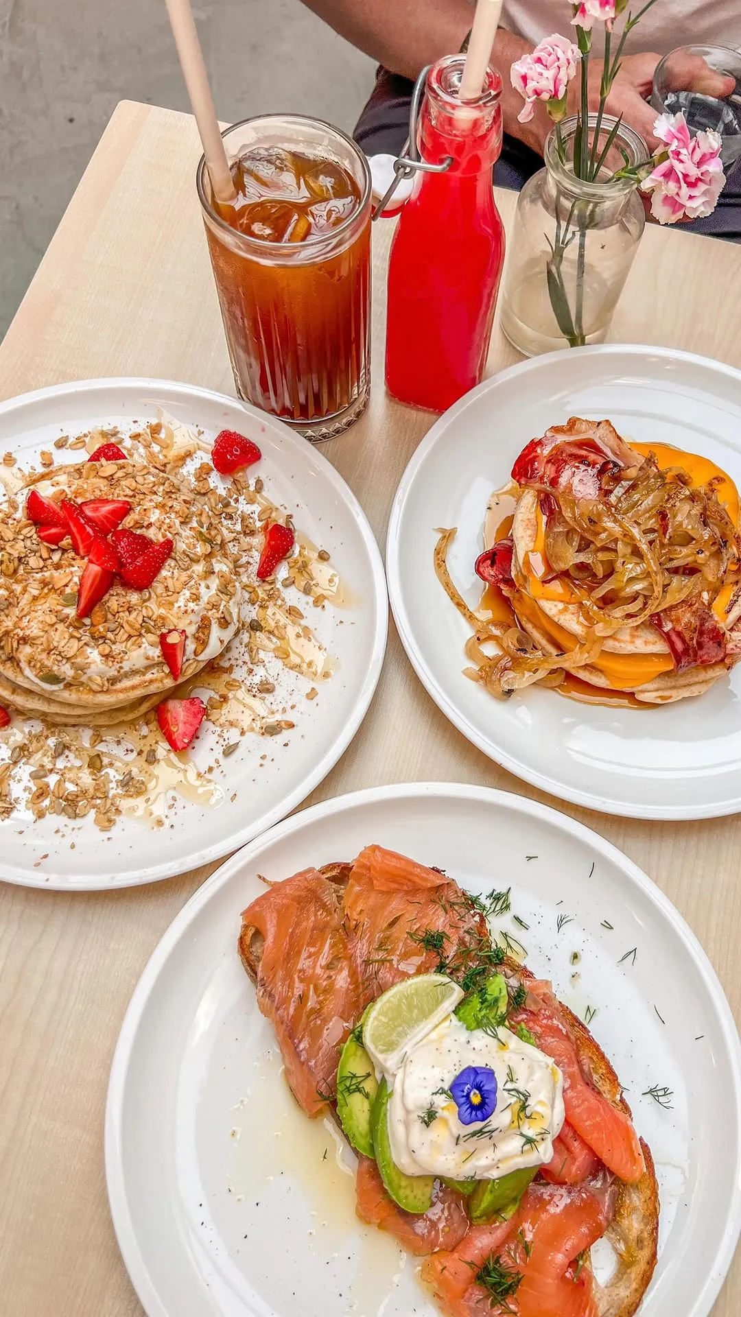The image is well-composed with an appealing overhead shot of three distinct food dishes and drinks. The lighting is soft and even, enhancing the textures and colors of the food. The main elements on the plates are sharp and in focus, contributing to a highly photo-realistic and appetizing presentation. Colors appear accurate and vibrant.