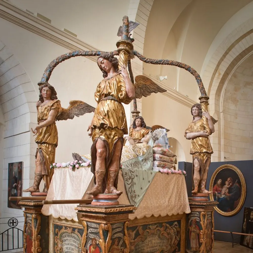 The image features a large, ornate wooden structure adorned with multiple golden statues of angels, likely an ancient altar or canopy, prominently displayed within what appears to be a museum or church setting.