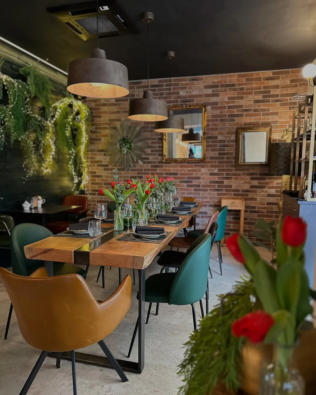 The image effectively captures a well-decorated restaurant dining area with appealing natural lighting and vibrant colors. However, the composition is slightly compromised by the out-of-focus foreground elements, and overall sharpness could be improved.