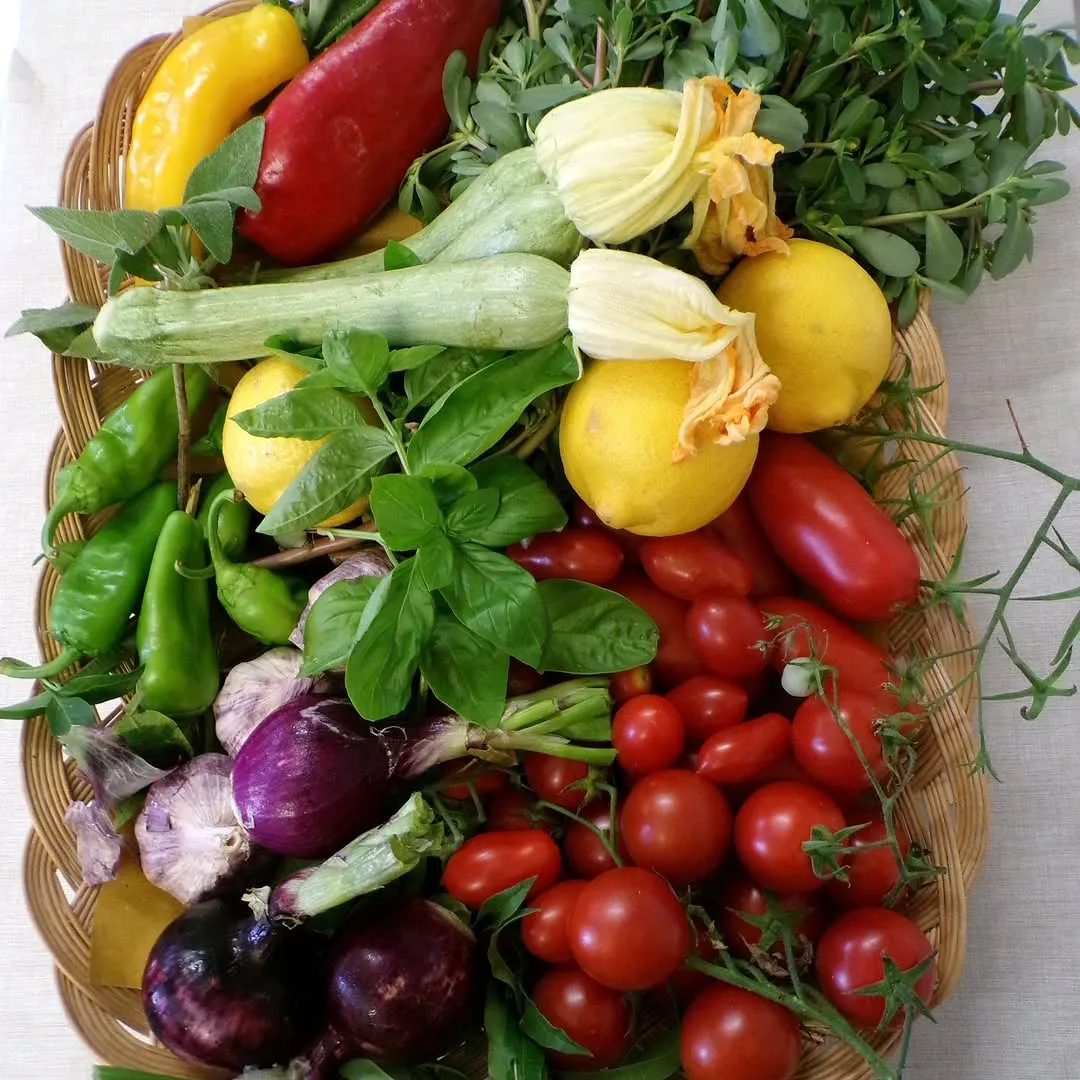 This image showcases a vibrant and well-composed assortment of fresh produce in a basket. The lighting is excellent, highlighting the natural colors and textures of the vegetables, making them appear highly photo-realistic. All key elements are sharp and in focus, contributing to a high-quality, appealing visual.