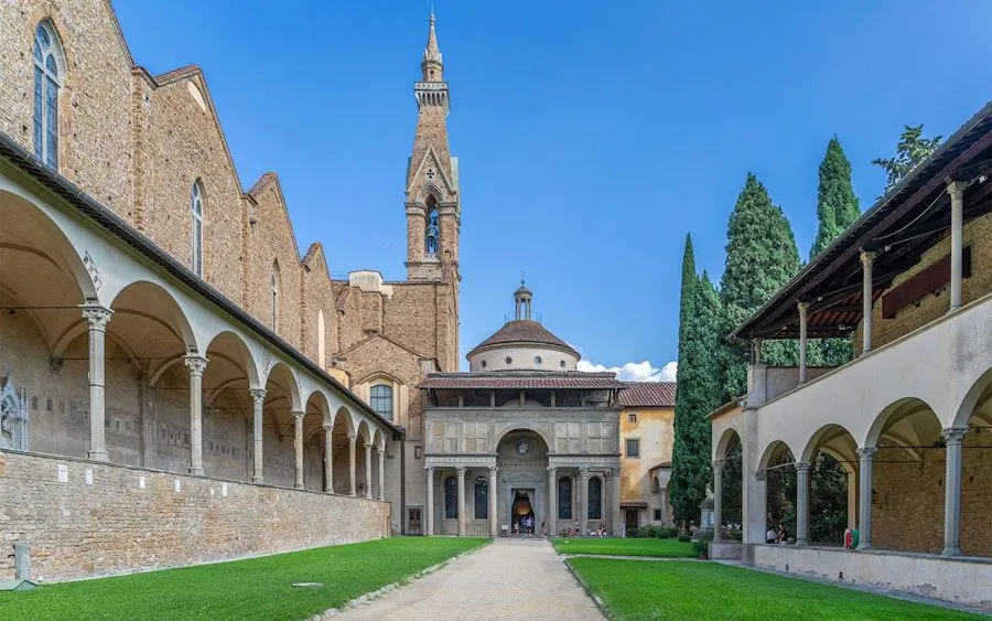 The image exhibits excellent composition with leading lines drawing the eye towards the central architectural elements. Lighting is bright and natural, illuminating the scene well. Sharpness is strong throughout, and colors appear accurate and vibrant, contributing to a high degree of photo-realism. All key elements, including the buildings and path, are in sharp focus.