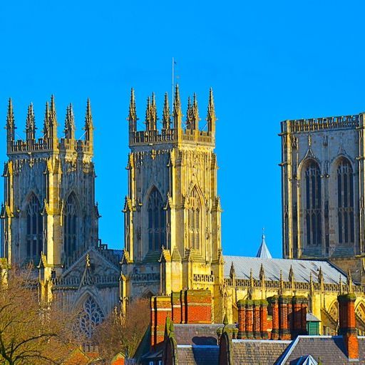 This image is a well-composed and well-lit photograph of York Minster, a famous cathedral in England. The image is sharp, with good color accuracy and a photo-realistic feel. The key elements, such as the towers and spires, are in focus. The image is free of unwanted elements, such as selfies, promotional graphics, advertisements, or cluttered environments. Overall, this is a high-quality image that effectively captures the beauty and grandeur of York Minster.