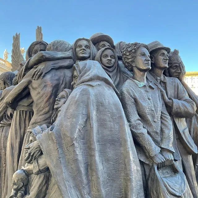 A well-composed and sharp photograph of a bronze sculpture depicting multiple figures. The natural lighting is excellent, illuminating the details and textures of the artwork. The colors are accurate, and the image is highly photo-realistic with all key elements in focus.