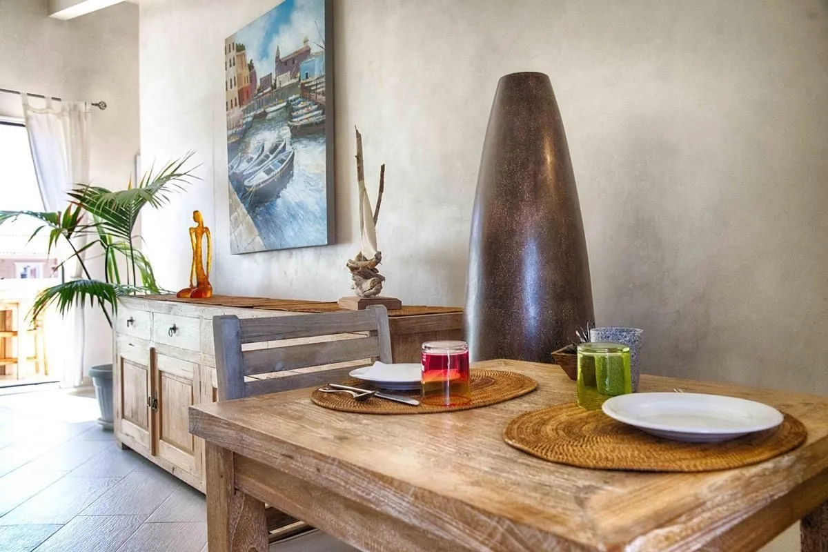 The image presents a well-lit and sharp view of a dining area, featuring a wooden table and chairs with decorative elements. The colors appear accurate and the image is highly photo-realistic, effectively capturing the scene.