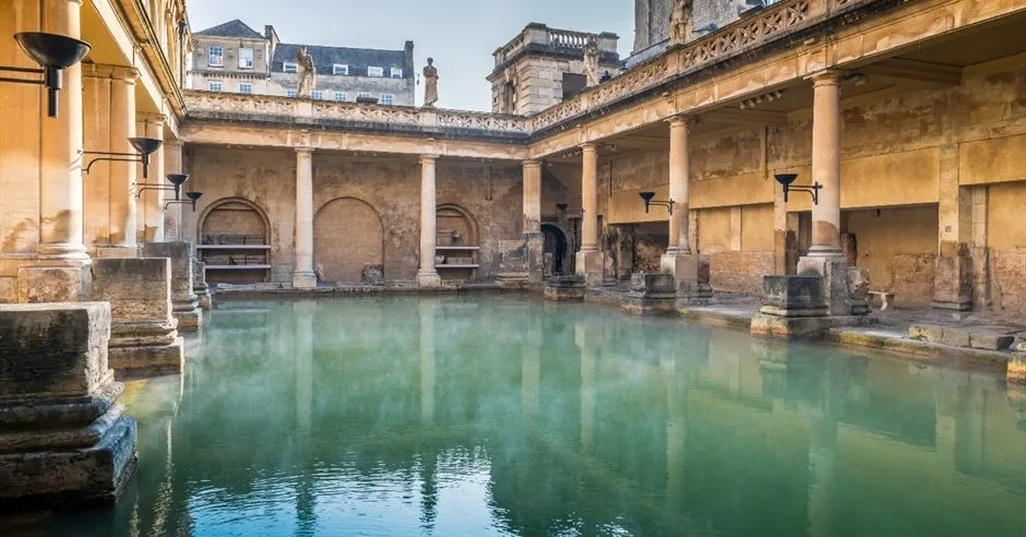 An editorial image showcasing the historic Roman Baths in Bath, England. The shot captures the architectural grandeur with the distinctive thermal water, conveying the atmosphere of this ancient site.