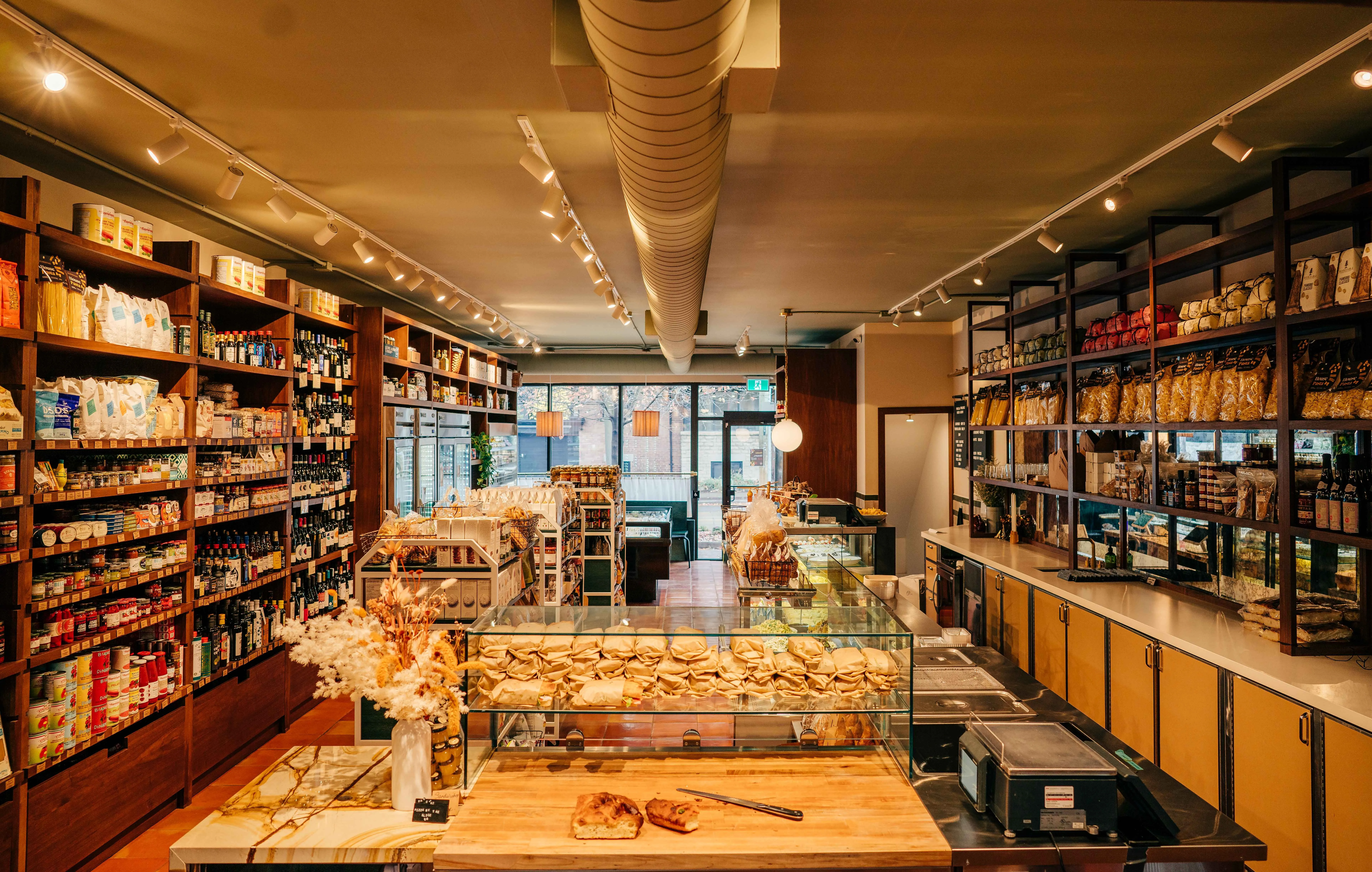 An inviting and well-captured interior view of a deli or bakery, showcasing a variety of food products on display.
