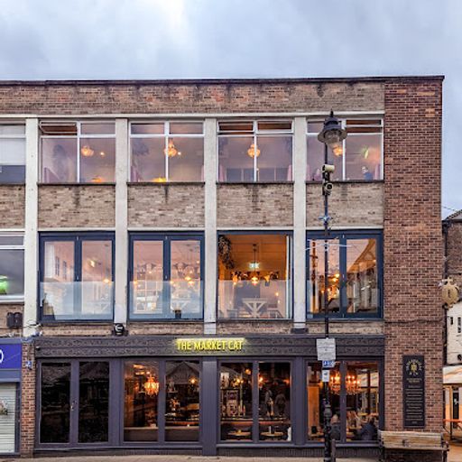 This image is an exterior shot of a restaurant. The composition is well-balanced, highlighting the building's facade. The lighting is good, providing even illumination, and the colors are accurate. The image is sharp, showcasing details like the brickwork and windows. The key elements, such as the restaurant's sign, are in focus. The image is photorealistic and does not contain any unwanted elements. The image is well-composed, well-lit, sharp, color-accurate, photo-realistic, and has key elements in focus. Therefore, it scores high on all criteria.