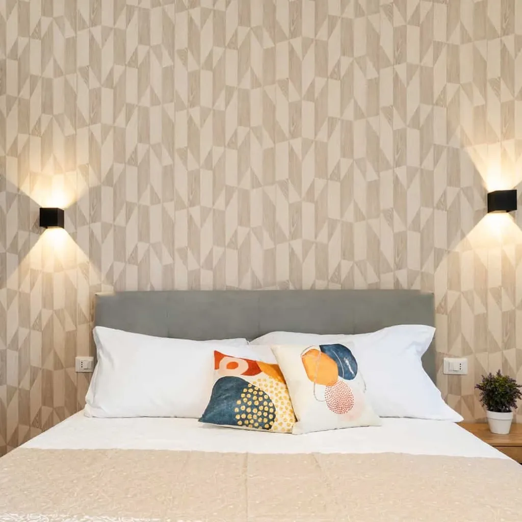 The image showcases a well-lit and sharp bedroom interior, highlighting the bed with its decorative pillows, headboard, and geometric wallpaper. The colors are accurate, and all key elements are in sharp focus, contributing to a high degree of photo-realism. The composition is clean and centered, presenting the space effectively.