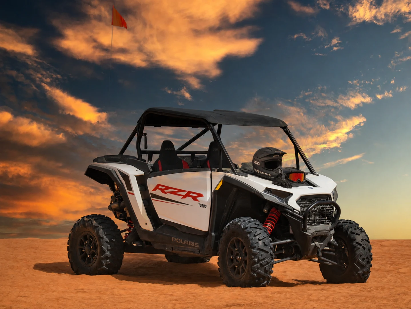 Safety gears while driving a dune buggy in red sand desert Dubai