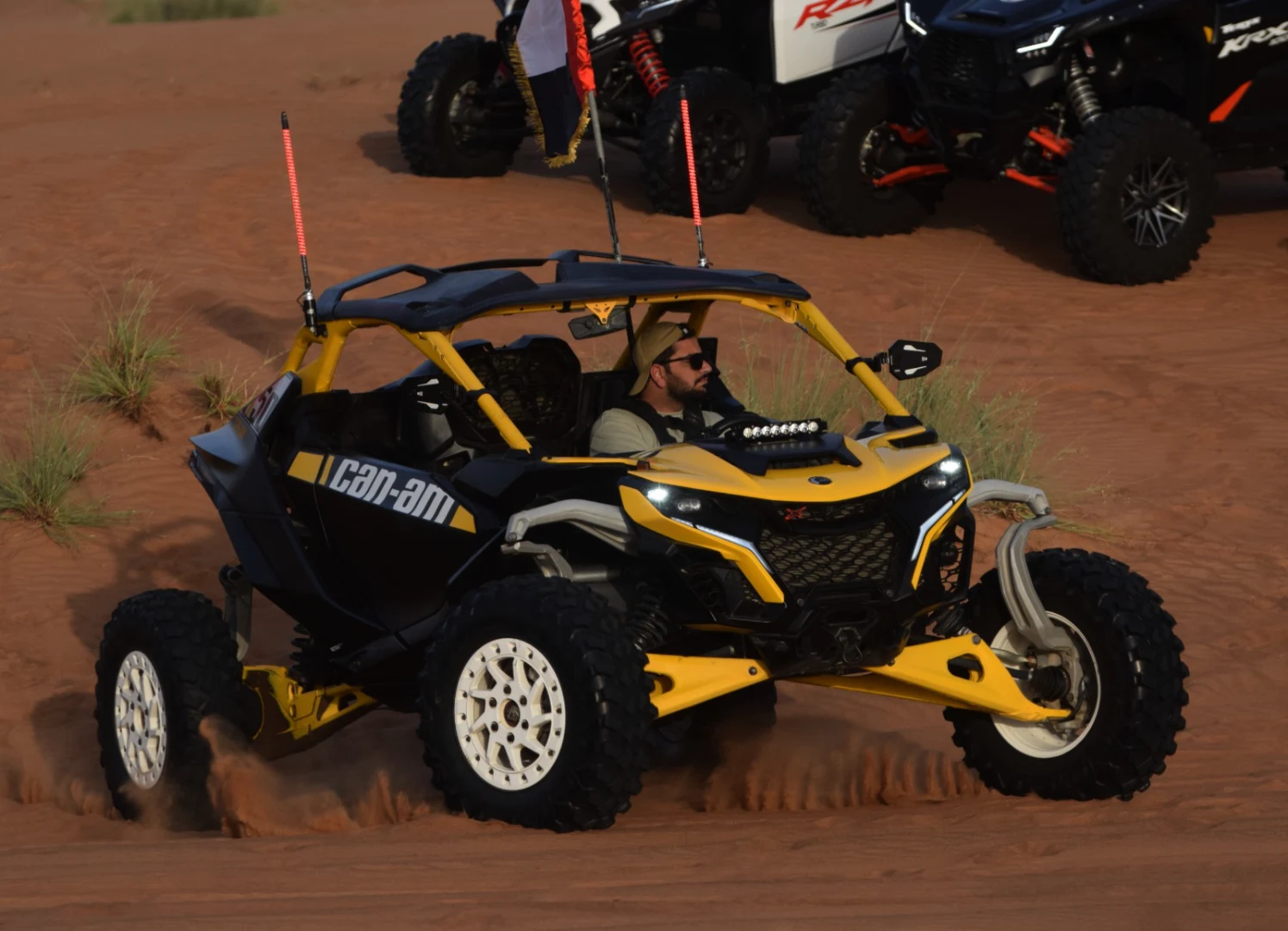 Can-Am Maverick R conquering Dubai red sand dunes during an offroad desert adventure with Offroad Rental Hub