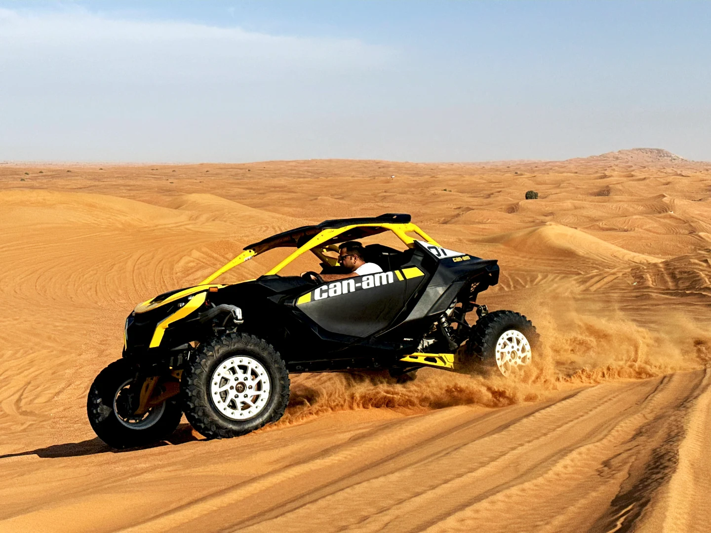 Can-Am Maverick R conquering Dubai red sand dunes during an offroad desert adventure with Offroad Rental Hub