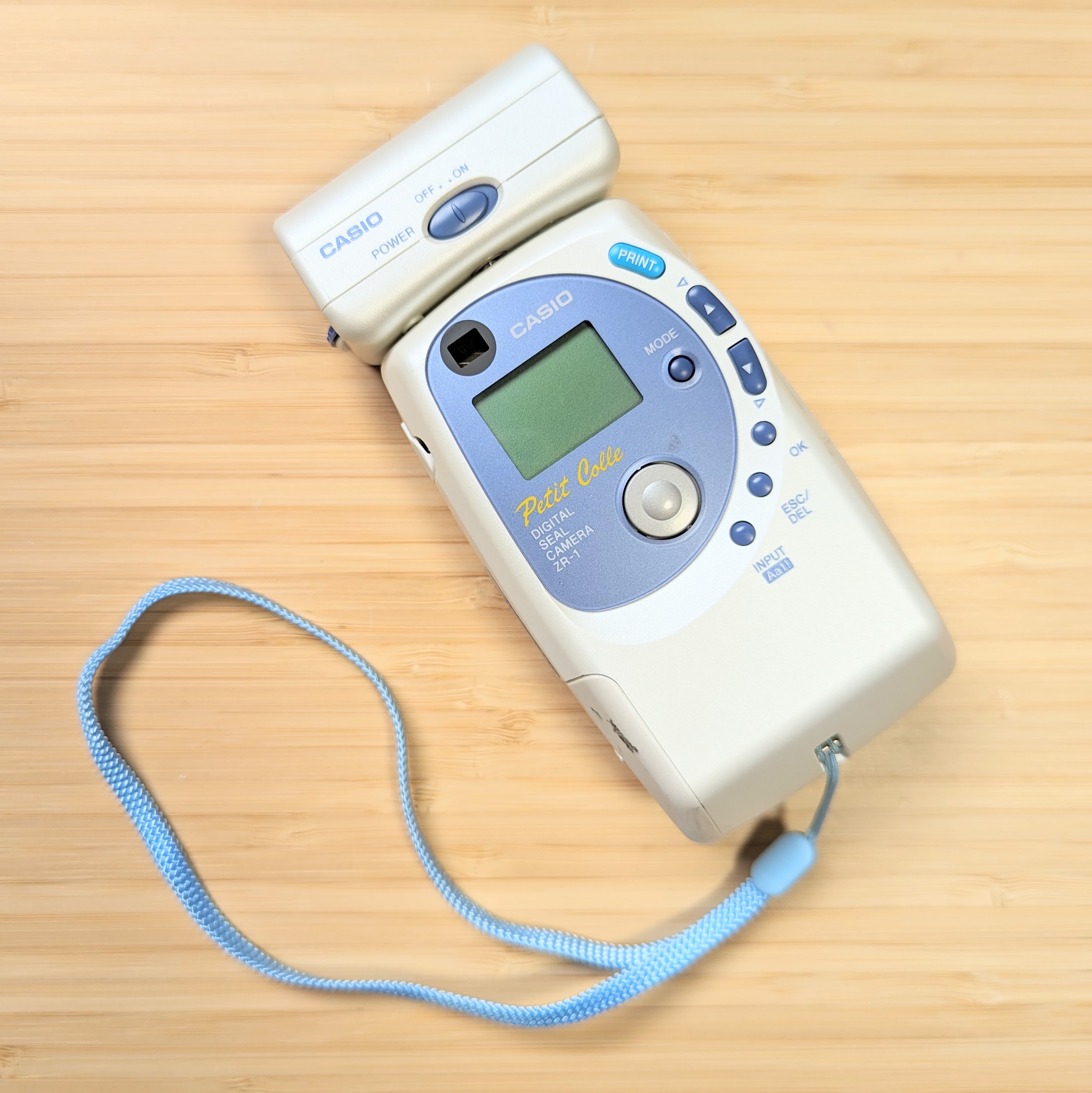 White and Blue Casio Petit Colle ZR-1 with Optional Flash on Top