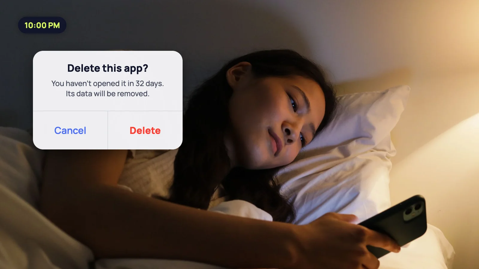 Woman in bed about to delete an app she has not opened in a month