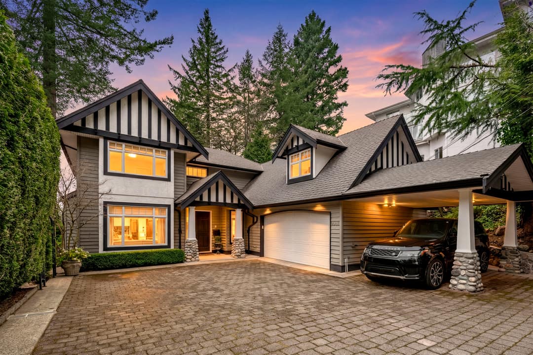 A before-and-after AI-enhanced exterior transformation of a luxury home in North Vancouver, featuring the addition of a high-end Range Rover in the carport, illuminated interior and exterior lighting, and a dramatic twilight sky transition.