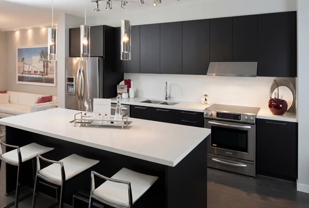 A before-and-after AI image upscale and restoration of a modern kitchen in Coquitlam, showing the transformation from a low-quality, pixelated original to a sharp, high-resolution professional photo with enhanced clarity and detail.