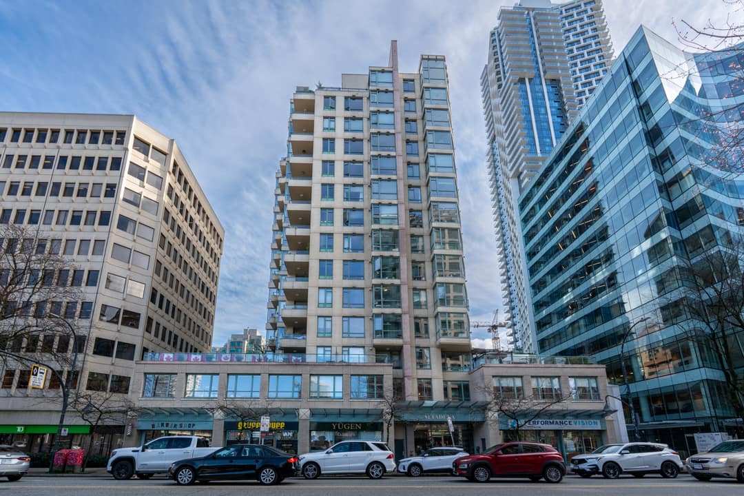 Daytime exterior architectural photography of a modern high-rise residential building in Downtown Vancouver, featuring a sleek glass and concrete facade.