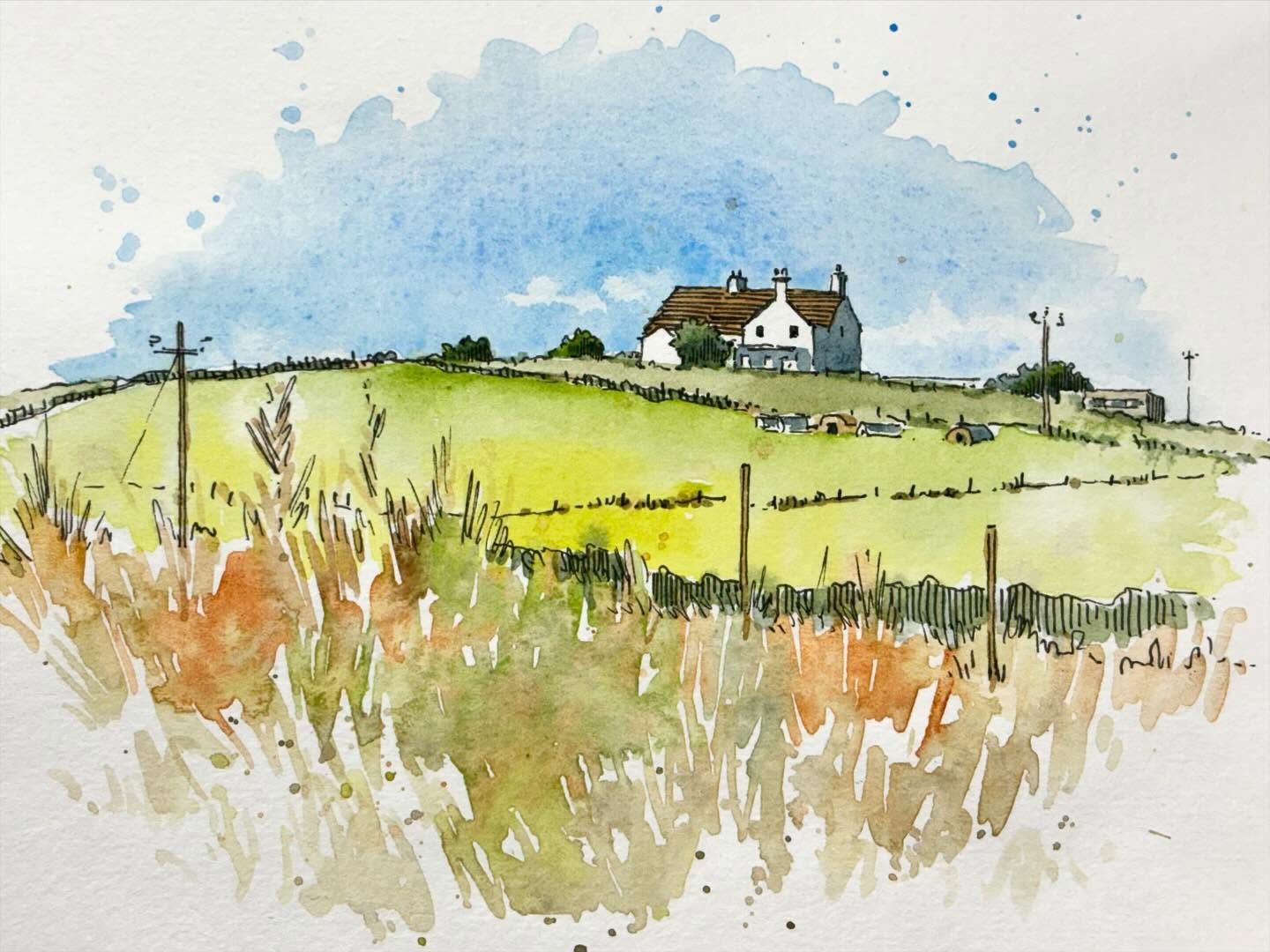 Watercolour sketch of a countryside landscape in Anglesea with a white building on the horizon.