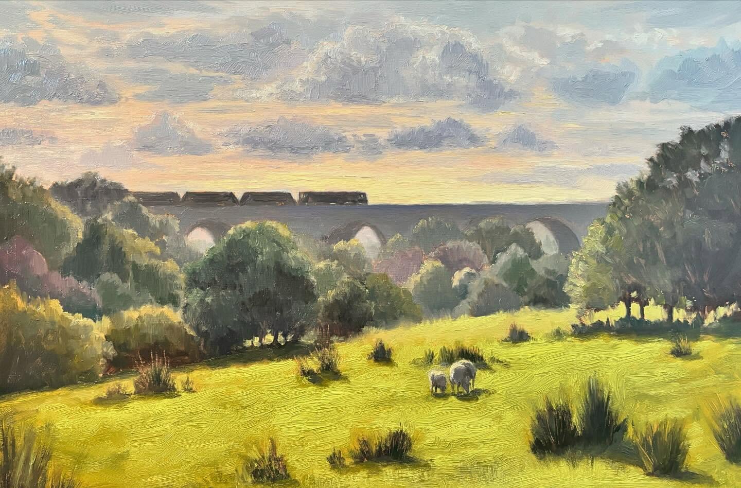 Oil painting of an evening landscape with a train crossing a viaduct in Chapel Milton, Derbyshire.