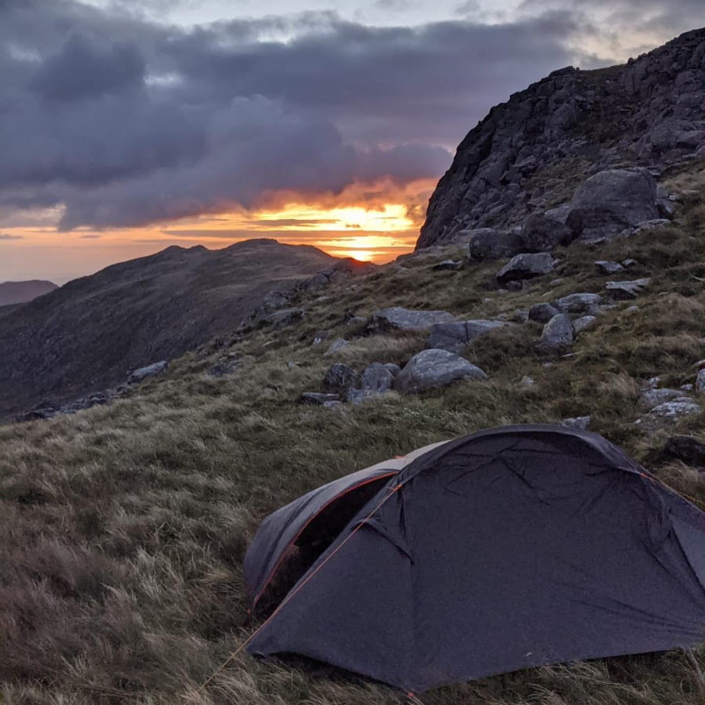 A tent pitched on the edge of Glyder Fawr in Snowdonia, Wales.