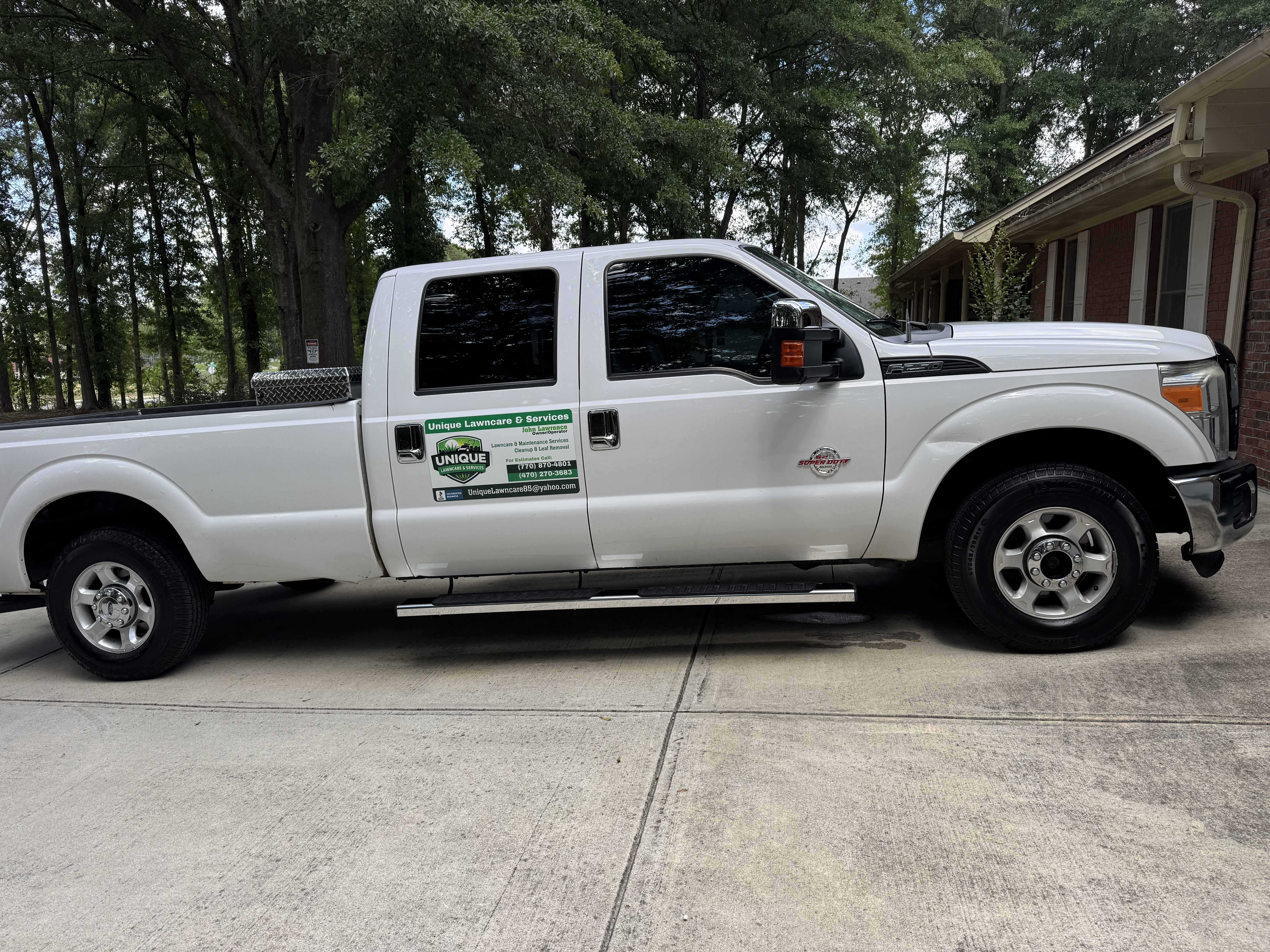 Company truck displaying lawncare services.