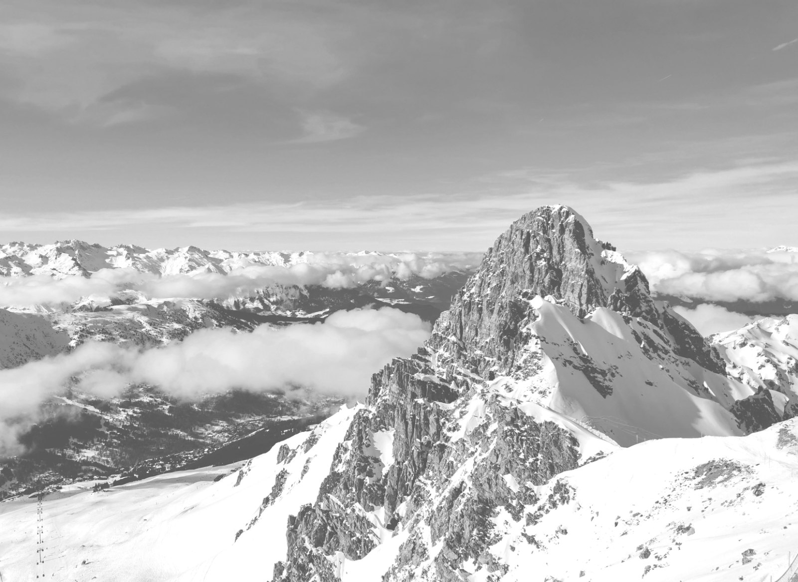 Understated black-and-white shot of a private jet on a quiet Alpine apron, such as Chambéry, with a helicopter waiting n