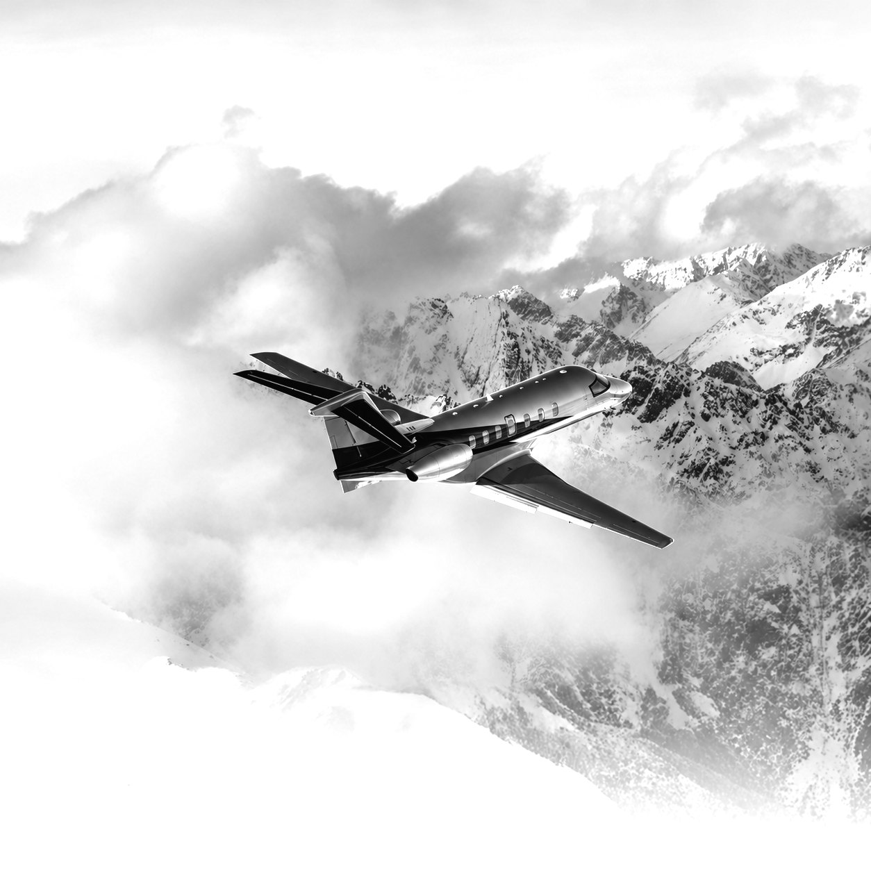 Business jet flying above clouds and mountains