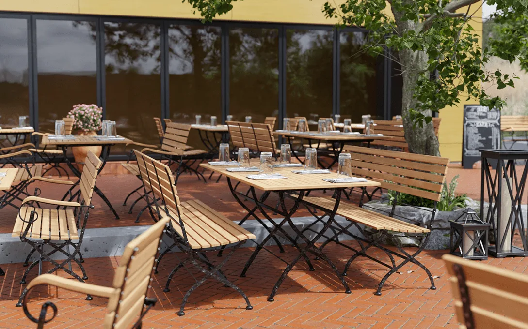 2-seater armrest bench Valentin in a reference hospitality setting