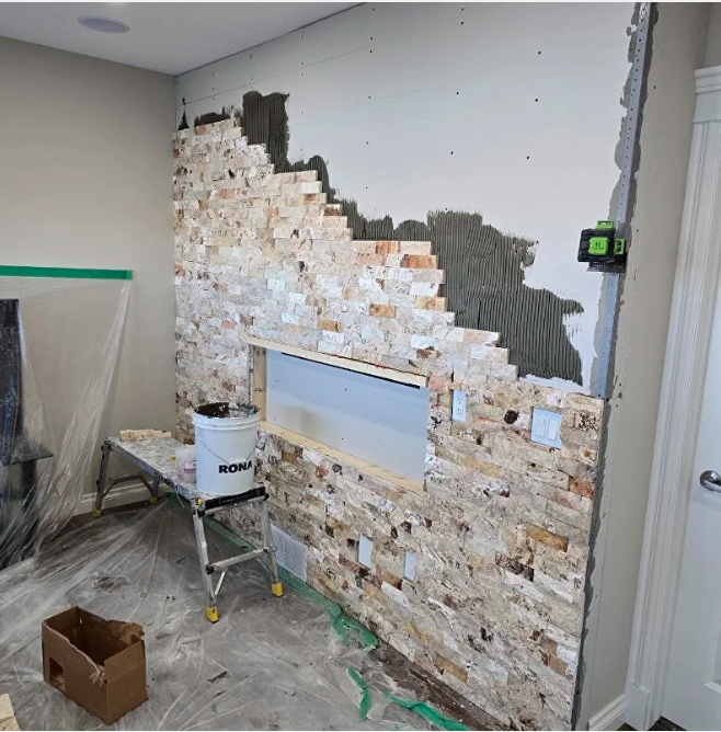 Wall preparation and tile installation in progress