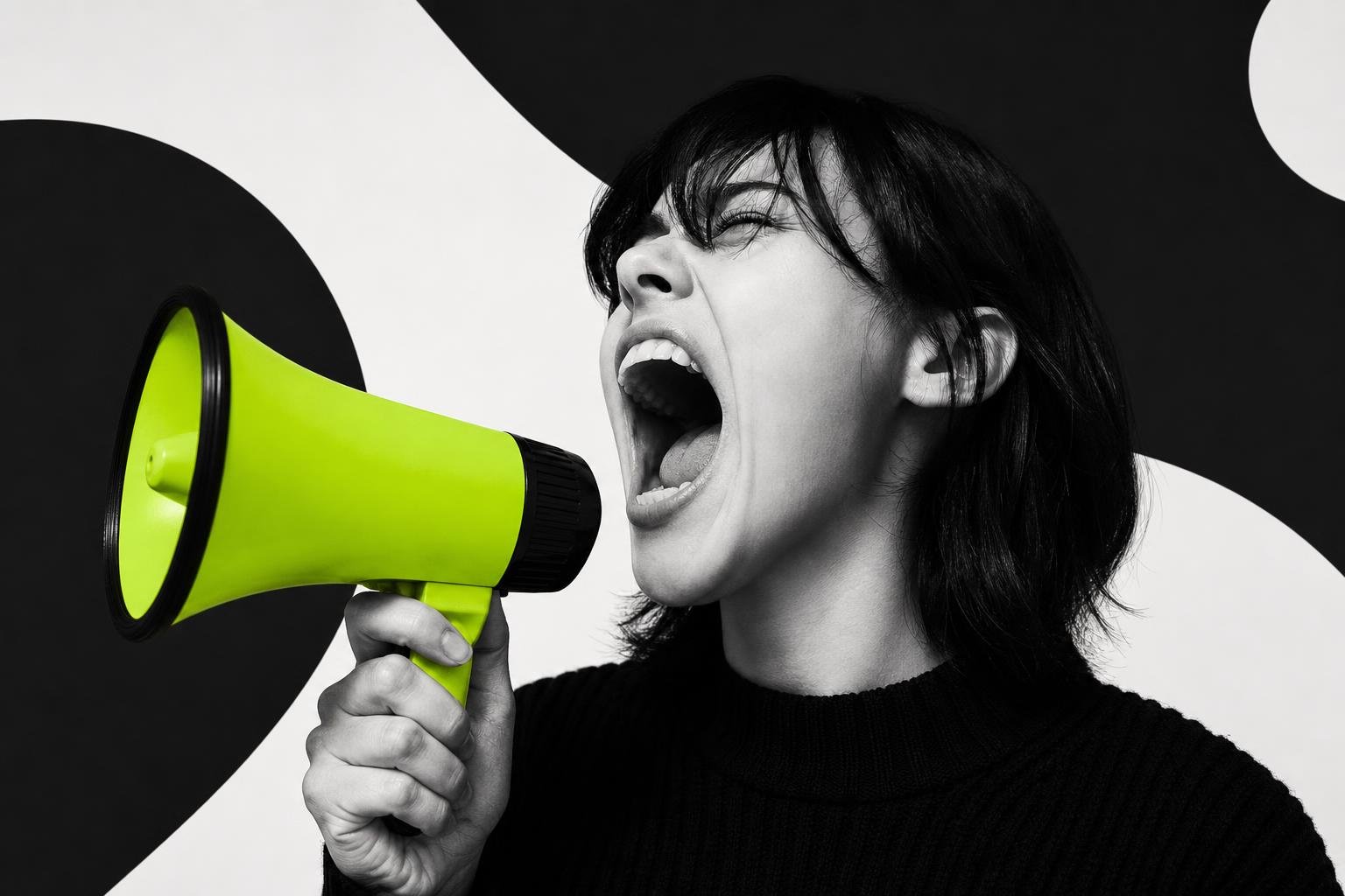 High-contrast black-and-white photo of a person shouting with mouth wide open, a single lime-colored prop highlighted in color