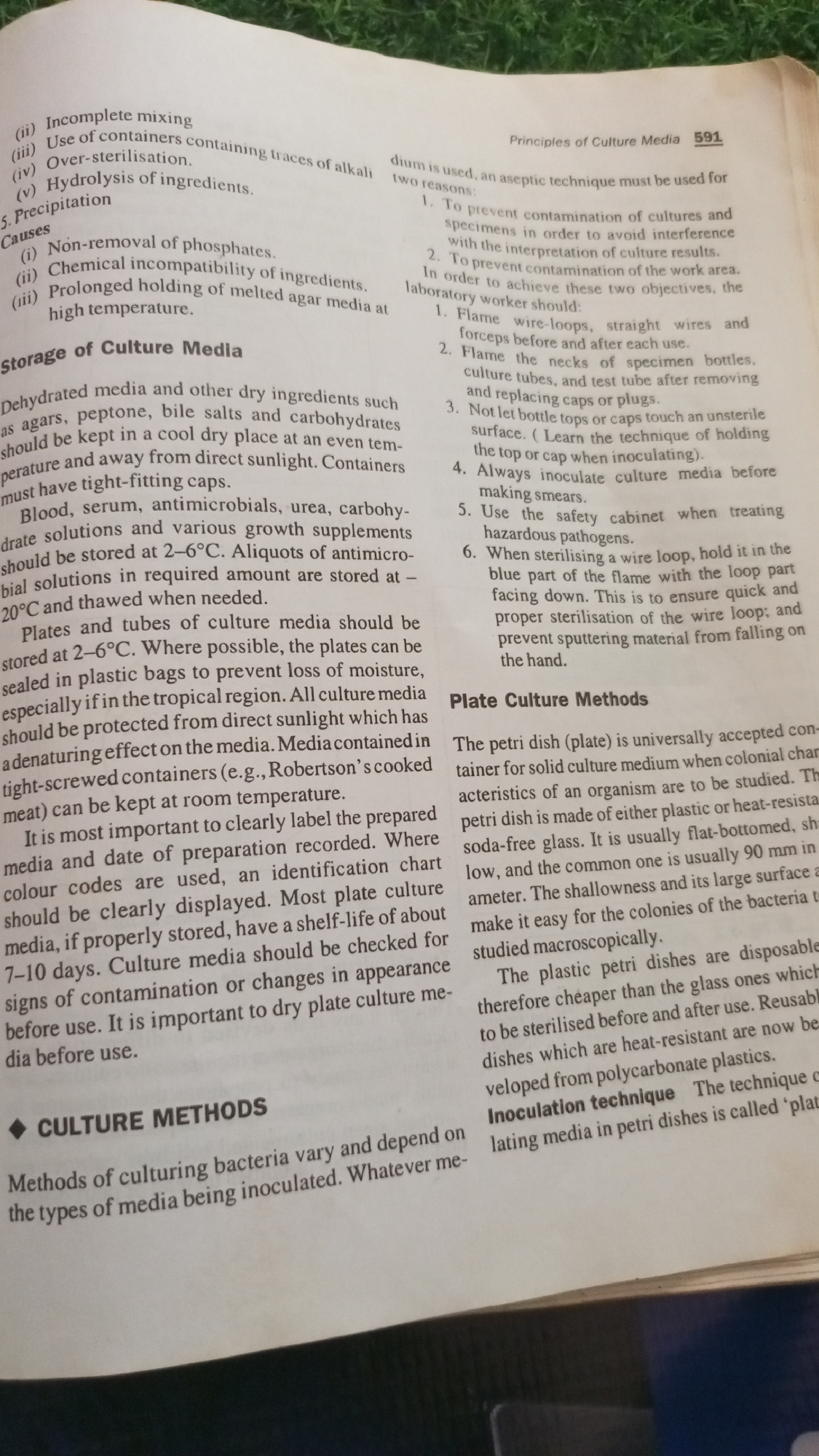 The image displays a page from a textbook or scientific document detailing principles of culture media and methods. The text is organized into sections with headings like "Principles of Culture Media," "Storage of Culture Media," and "Culture Methods," and "Plate Culture Methods." The content discusses issues like incomplete mixing, over-sterilization, and hydrolysis of ingredients, as well as proper storage of dehydrated media, blood, serum, and antimicrobial solutions. It also covers the preparation and storage of plates and tubes of culture media, emphasizing labeling and shelf-life. A subsection on "Culture Methods" begins to describe various techniques for culturing bacteria. The page exhibits typical printing and paper texture.
There is no information in the image to suggest it is located in Jalingo, Nigeria, or any other specific geographical location.