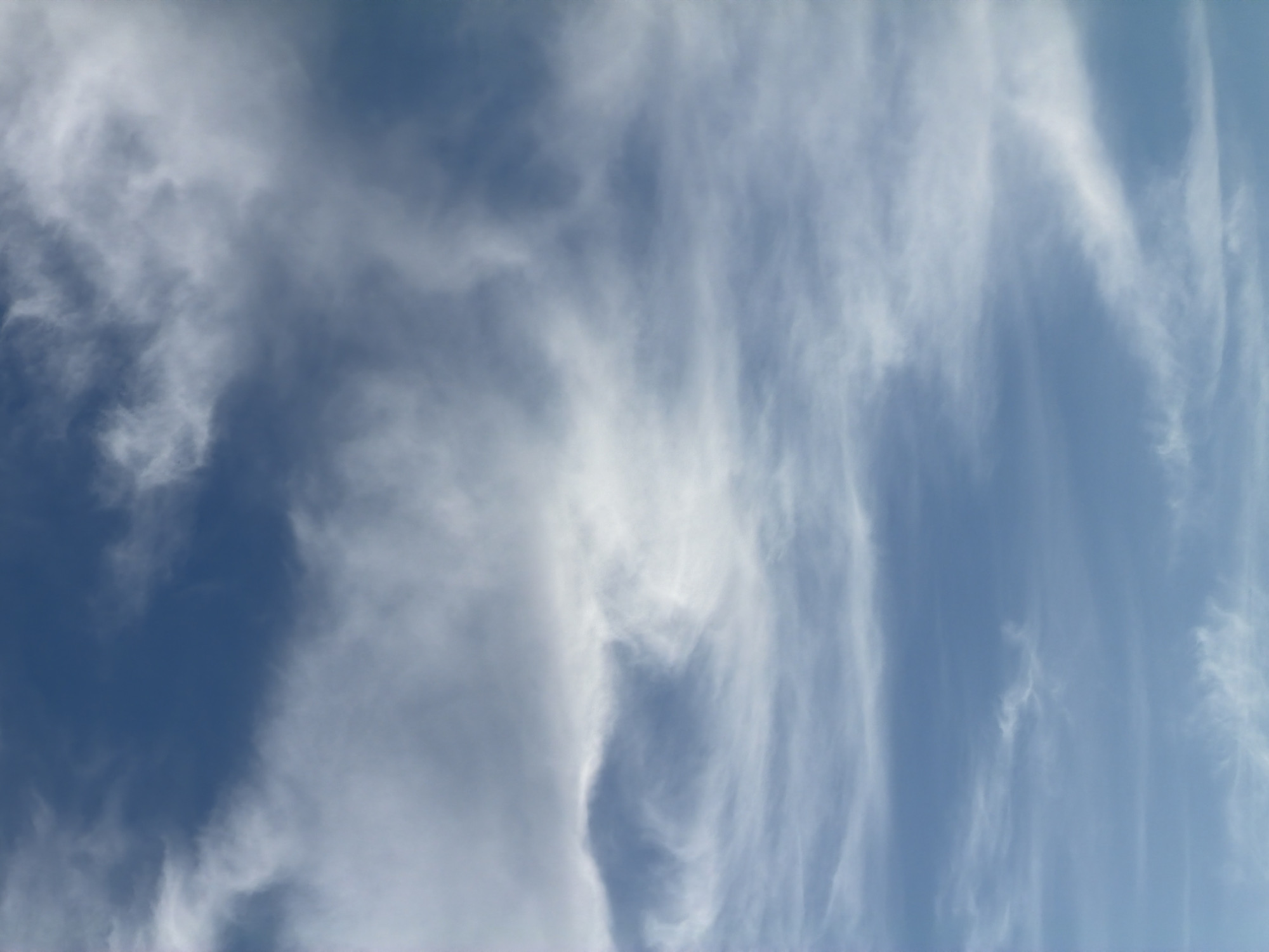 The image shows a daytime sky with cirrus clouds. The sky is light blue and the clouds are white and wispy. It is not possible to determine the location of the image as North Kuta, Indonesia, without additional information.