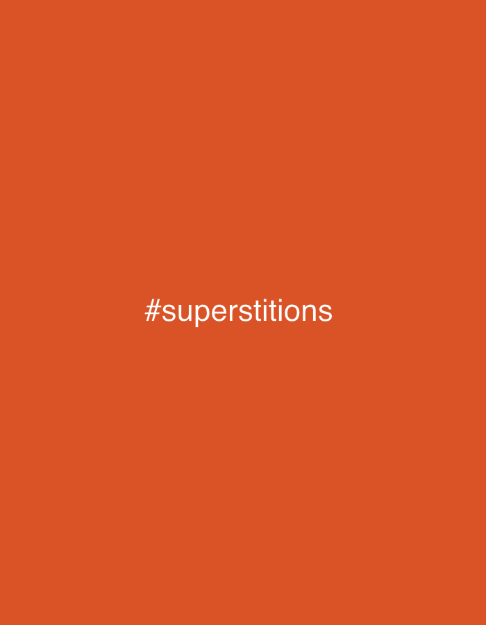 The image is a plain orange background with the text "#superstitions" in white, centered on the lower half of the frame. There is no indication of the city of Jos, Nigeria, or any other location. The image contains no people, subjects, objects, or actions.