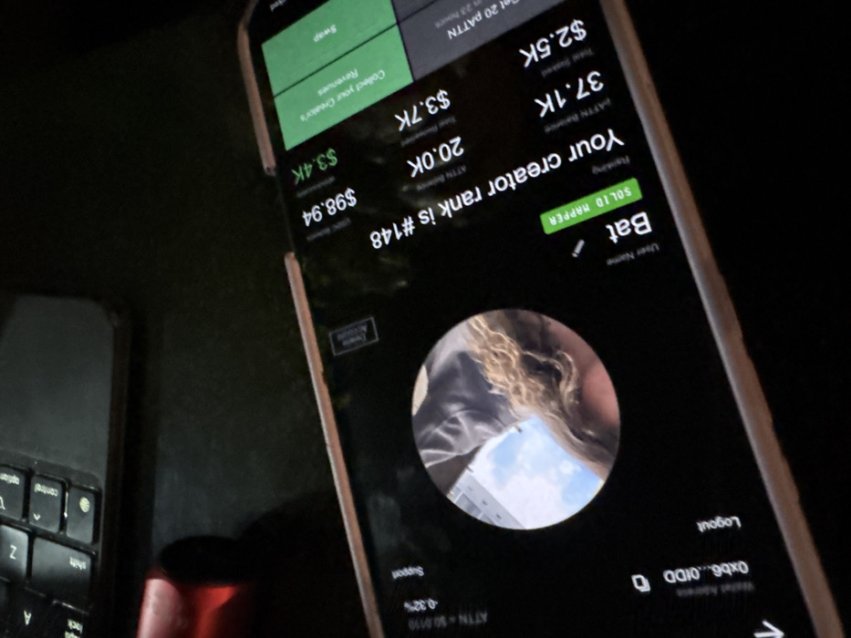 The image displays a smartphone screen showing a creator dashboard for an online platform. The username is "Bat," with a ranking of "SOLID MAPPER" and a creator rank of #148. The dashboard indicates a "Total Susked" value of $2.5K, an "ATTN Balance" of 37.1K, and an ATN B value of 20.0K. The user has earned $3.7K total revenue, with $3.4K in USBC revenue at $98.94. The screen also shows options for swapping and collecting creator's revenue. A logout option and wallet address are visible at the bottom. A keyboard is present to the left.