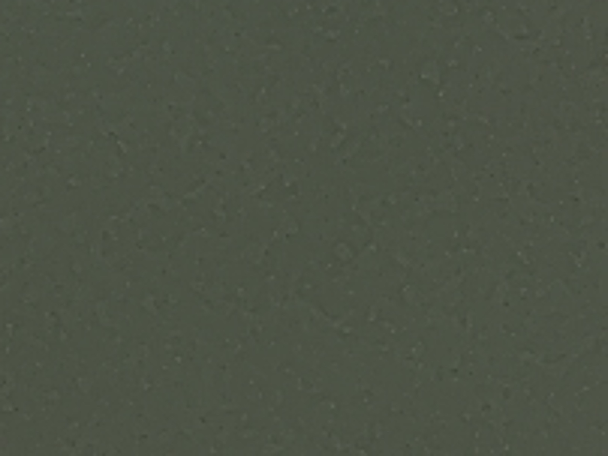 The image provided is a close-up, texture-based image. It displays a uniform, dark greenish-gray surface with subtle variations in tone and a fine, granular texture. There are no discernible objects, people, actions, or interactions present in this image. The image appears to be a detail of a material or surface, rather than a scene from a specific location. Therefore, it is not possible to determine its location in the city of Kalekovets, Bulgaria, or provide any further contextual details.