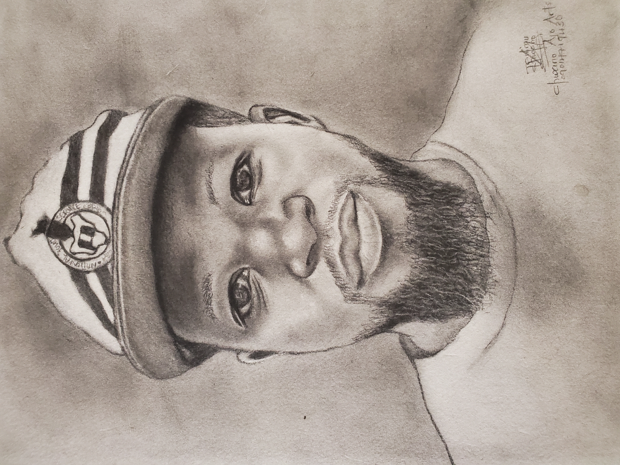 The image is a grayscale drawing of a man wearing a striped cap with a circular emblem, likely a portrait. The man has a beard. The drawing appears to be signed "Chukwuna Alo Arts" with what might be a date, "9/04/19/30". There is no other information in the image to confirm the location as Mararaba, Nigeria. The portrait does not provide sufficient detail to discern any actions, interactions, or specific details about the environment.