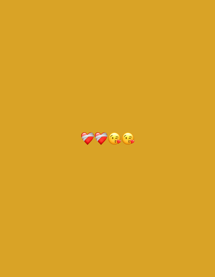 The image shows a plain, mustard-yellow background. In the center of the lower portion of the image, there are four emojis arranged horizontally. From left to right, there are two red heart emojis with white stripes, followed by two yellow face emojis with puckered lips, in a kissing gesture. The scene does not provide any information or visual cues related to the city of Barden Yana, Nigeria.