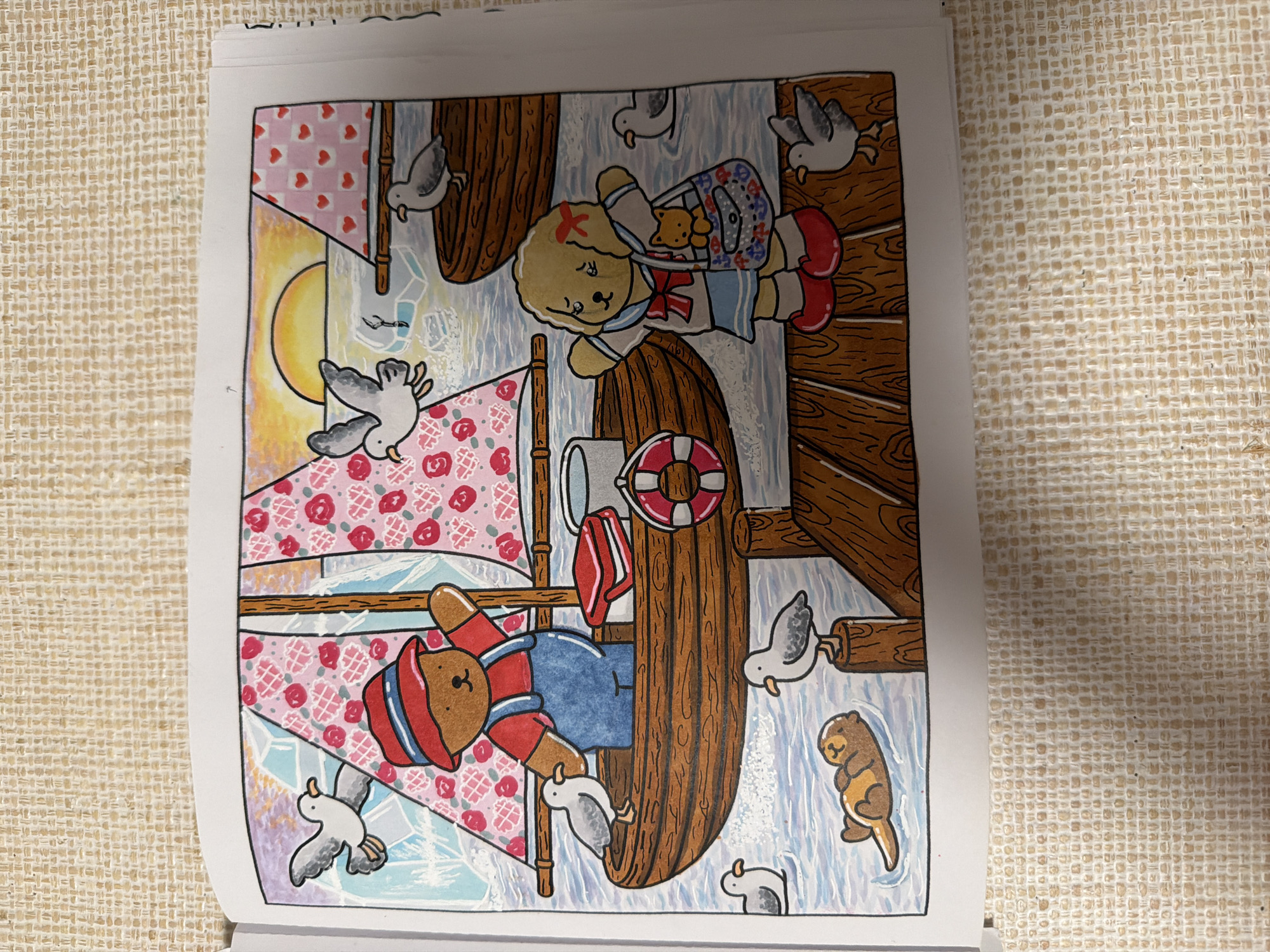 The image depicts a colorful illustration of a seaside scene. In the foreground, a wooden dock extends into the water. A yellow dog wearing a sailor outfit stands on the dock, holding a purse containing a small brown teddy bear. Several seagulls are scattered around the dock and in the water. To the left, a brown bear in a red hat and blue overalls stands in a wooden boat with a red and white striped sail adorned with pink roses. Another boat with a pink sail decorated with red hearts is visible in the background, near a sunset over the water. A sea otter floats peacefully in the water near the dock. The image is rendered in a whimsical, cartoonish style, suggesting it is from a children's book or coloring page. The specific location in Boca Raton, United States of America, cannot be determined from the provided image.