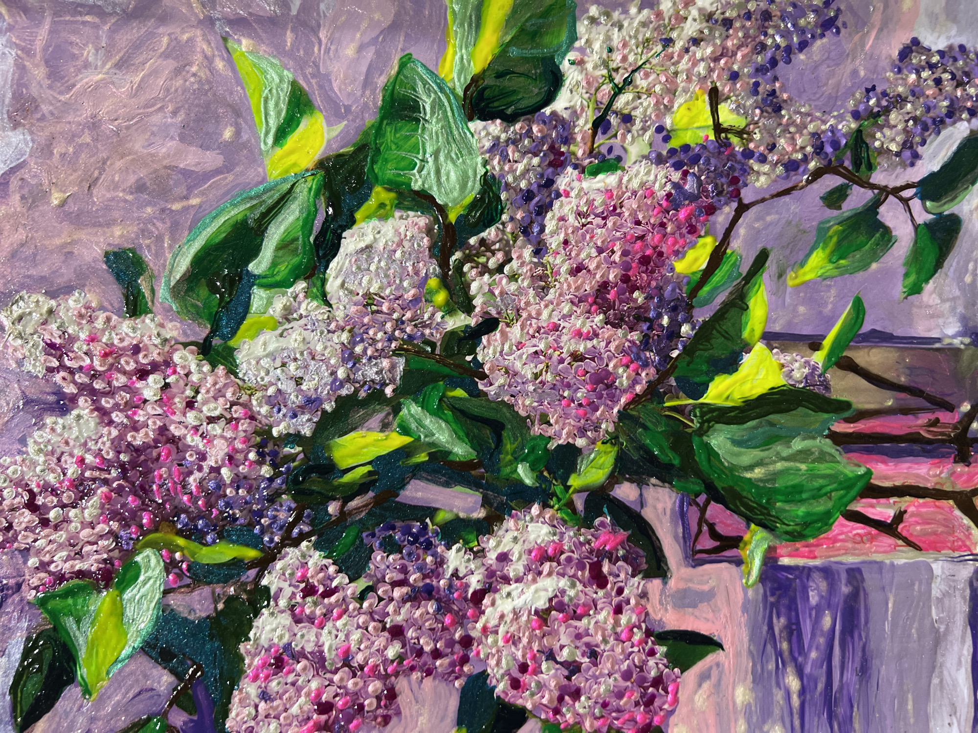 This is an oil painting of a bouquet of lilacs in a vase. The lilacs are depicted in various shades of pink, purple, and white, with textured petals that give the flowers a three-dimensional quality. Green leaves are interspersed throughout the bouquet, some with a yellow hue. The background is a soft, impressionistic wash of purple and pink, suggesting a diffused light. The vase appears to be made of glass with a pinkish hue and is partially visible at the bottom left of the frame. The painting is an artwork and not a photograph of a real-world scene, therefore it cannot be located in Minsk, Belarus or any other specific geographical location.