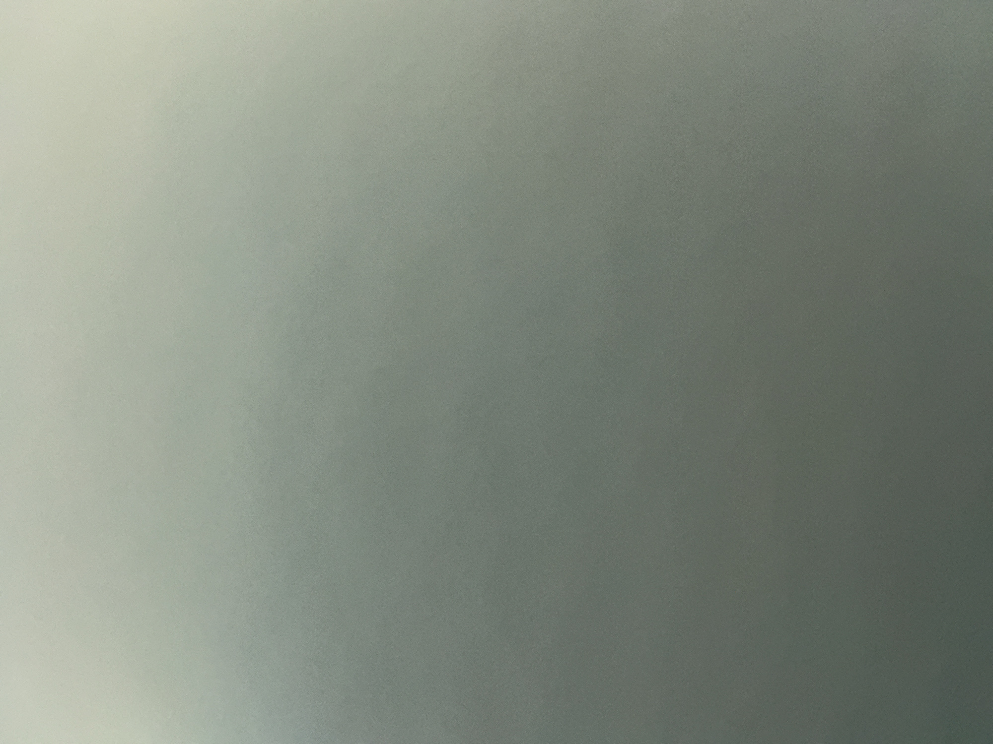 This is an abstract image of a gradient of gray. There is no discernible location in Los Ramos, Spain, nor are there any people, subjects, objects, actions, interactions, or environmental details visible. The image appears to be a plain surface with subtle variations in light and shadow.