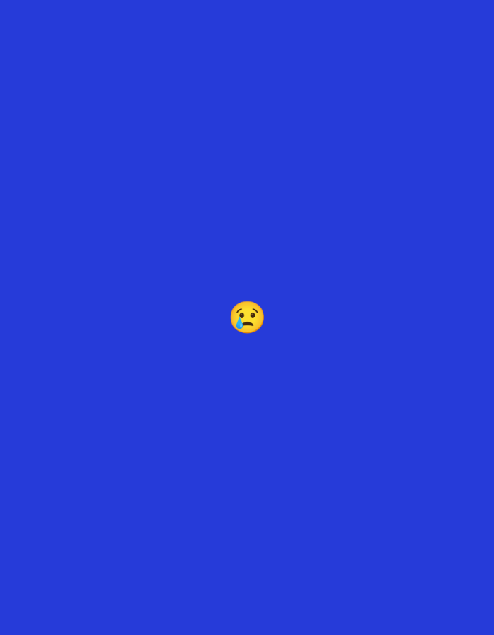 The image displays a digital graphic consisting of a single, uniformly colored royal blue background (#363AF3). Centrally positioned within the upper-middle section of the frame is a single yellow "crying face" emoji. The emoji features a round yellow face with slightly arched eyebrows, small closed eyes, an inverted crescent-shaped mouth, and a single blue tear drop emanating from the viewer's left eye. The overall composition is minimalist, with no other subjects, objects, or environmental elements present. This image does not depict a real-world scene or location, thus no information regarding a specific city or geographical area can be ascertained.